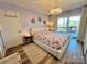 Serene main bedroom featuring a king bed, chandelier, and access to a private balcony at 9009 Cebu Ct, Fort Mill, SC 29708