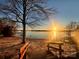 Waterfront view from a sandy beach, a wooden staircase with handrails leading down to the lake at 9009 Cebu Ct, Fort Mill, SC 29708