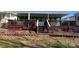 Enclosed back porch with red lattice and access to a covered deck overlooking yard at 103 Dogwood Cir, New London, NC 28127