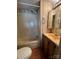 Bathroom with a shower-tub combination, matching vanity and toilet at 103 Dogwood Cir, New London, NC 28127