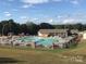 Community pool and bathhouse featuring lounge seating, and a picnic area, ideal for residents and guests at 103 Dogwood Cir, New London, NC 28127