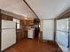 Compact kitchen featuring laminate floors, wood cabinets and appliances at 103 Dogwood Cir, New London, NC 28127