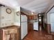 Compact kitchen features wood cabinets and appliances with linoleum floor at 103 Dogwood Cir, New London, NC 28127