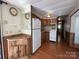Retro kitchen with wood cabinets, white appliances, and wood flooring at 103 Dogwood Cir, New London, NC 28127
