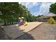 Well-maintained community playground with slide, swings, and covered picnic area in a lush green space at 103 Dogwood Cir, New London, NC 28127