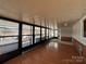 A sun room is lined with windows offering a view of the lake at 103 Dogwood Cir, New London, NC 28127