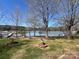 Relaxing waterfront view with lush lawns, providing a serene escape with dock access at 103 Dogwood Cir, New London, NC 28127