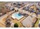 A high angle showcases the neighborhood pool, playground, parking, and the community it serves at 11502 Wilson Mill Ln, Pineville, NC 28134