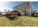 Spacious backyard with a wooden deck, pergola, and a lush lawn, ideal for outdoor activities and gatherings at 11502 Wilson Mill Ln, Pineville, NC 28134