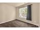 Bedroom featuring a large window with curtains and neutral colored walls and carpet at 11502 Wilson Mill Ln, Pineville, NC 28134