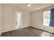 Bedroom featuring neutral walls and carpet with a window with curtains and doorway to another room at 11502 Wilson Mill Ln, Pineville, NC 28134