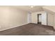 Large bedroom featuring a neutral colored walls and carpet with a view to an adjoining room at 11502 Wilson Mill Ln, Pineville, NC 28134
