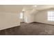 Large bedroom featuring a vaulted ceiling with a window and neutral walls and carpet at 11502 Wilson Mill Ln, Pineville, NC 28134