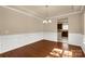 Dining room featuring hardwood floors, wainscoting, and chandelier at 11502 Wilson Mill Ln, Pineville, NC 28134