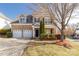 Charming two-story brick home with a well-manicured lawn and an attached two-car garage at 11502 Wilson Mill Ln, Pineville, NC 28134
