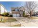 A brick facade two-story home with a two car garage, well-maintained landscaping, and mature trees at 11502 Wilson Mill Ln, Pineville, NC 28134