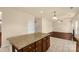 Kitchen island bar between the kitchen and living room with fireplace at 11502 Wilson Mill Ln, Pineville, NC 28134