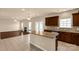 Kitchen area with island bar flowing into living space with fireplace at 11502 Wilson Mill Ln, Pineville, NC 28134