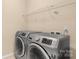 The laundry room includes a modern washer and dryer and wire shelving at 11502 Wilson Mill Ln, Pineville, NC 28134