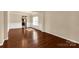 Bright living room with dark hardwood floors and white trim at 11502 Wilson Mill Ln, Pineville, NC 28134