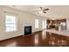Living room and kitchen with hardwood floors, fireplace, and stainless appliances at 11502 Wilson Mill Ln, Pineville, NC 28134