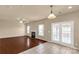 Living room featuring a fireplace, ceiling fan, and access to the back patio at 11502 Wilson Mill Ln, Pineville, NC 28134