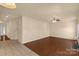 Open living room features hardwood floors, neutral paint, and a ceiling fan at 11502 Wilson Mill Ln, Pineville, NC 28134