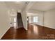 Bright living room features hardwood floors, staircase, and natural light at 11502 Wilson Mill Ln, Pineville, NC 28134