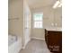A bright main bathroom offers a soaking tub, walk-in shower, and vanity at 11502 Wilson Mill Ln, Pineville, NC 28134