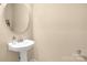 Neat powder room featuring stylish pedestal sink and modern fixtures at 11502 Wilson Mill Ln, Pineville, NC 28134