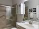 Bathroom with glass door shower, towel rack, and vanity with potted plant at 1220 Avalon Pl, Matthews, NC 28104