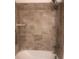 Bathroom features a tiled shower with a built-in shelf and a shower head with a handheld wand at 1220 Avalon Pl, Matthews, NC 28104