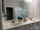 Bright bathroom with double sinks, a large mirror, and modern fixtures at 1220 Avalon Pl, Matthews, NC 28104