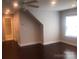 Bright bedroom featuring hardwood floors, neutral walls, and a ceiling fan with overhead lighting at 1220 Avalon Pl, Matthews, NC 28104