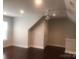 Bonus room with dark wood floors, a ceiling fan, and neutral paint at 1220 Avalon Pl, Matthews, NC 28104