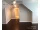 Bonus room with dark wood floors and neutral paint at 1220 Avalon Pl, Matthews, NC 28104