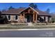 Community clubhouse featuring stone accents, covered porch and well-maintained landscaping at 1220 Avalon Pl, Matthews, NC 28104