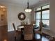 Inviting dining area with round table, woven chairs, and a view to a cozy outdoor sitting space at 1220 Avalon Pl, Matthews, NC 28104