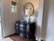 Welcoming entryway with a chest, decorative mirror, and lamp, offering a glimpse of the interior's refined style at 1220 Avalon Pl, Matthews, NC 28104