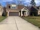 Charming home with a stone facade, covered entryway, two-car garage, and well-maintained landscaping at 1220 Avalon Pl, Matthews, NC 28104