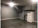 An unfinished garage with shelving for storage and enough room for a fridge or second freezer at 1220 Avalon Pl, Matthews, NC 28104