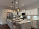 Spacious kitchen has a large island with bar seating, stainless steel appliances, and white cabinets at 1220 Avalon Pl, Matthews, NC 28104