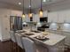 Modern kitchen with white cabinets, stainless steel appliances, and a spacious island with seating at 1220 Avalon Pl, Matthews, NC 28104