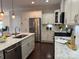 Well-lit kitchen boasts stainless appliances, white cabinets and a large island with breakfast bar seating at 1220 Avalon Pl, Matthews, NC 28104