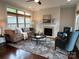 Bright living room with a cozy fireplace, comfortable seating, and a stylish rug, creating a welcoming atmosphere at 1220 Avalon Pl, Matthews, NC 28104