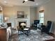 Bright living room with a decorative fireplace, stylish furnishings, and large windows for natural light at 1220 Avalon Pl, Matthews, NC 28104