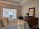 Spacious main bedroom featuring a tray ceiling, a sitting area, and hardwood floors at 1220 Avalon Pl, Matthews, NC 28104