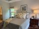 Tranquil main bedroom featuring a large window, bedside tables, and natural light at 1220 Avalon Pl, Matthews, NC 28104