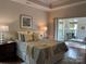 Spacious main bedroom featuring a tray ceiling, a sitting area, and hardwood floors at 1220 Avalon Pl, Matthews, NC 28104