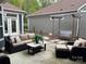 A relaxing patio featuring a cushioned sofa, comfortable chairs, a swing, and a view of the backyard at 1220 Avalon Pl, Matthews, NC 28104